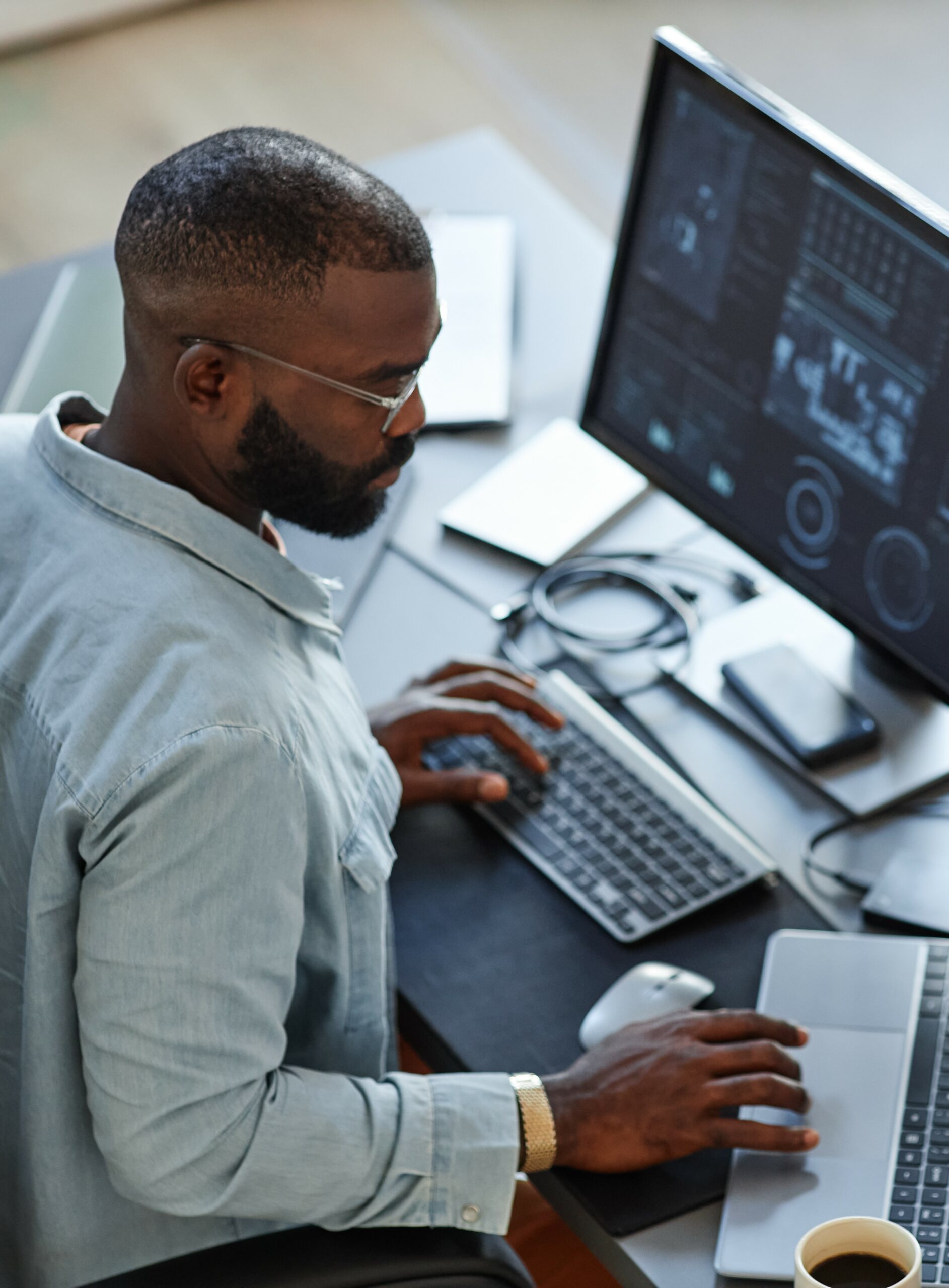 Man working on two laptops