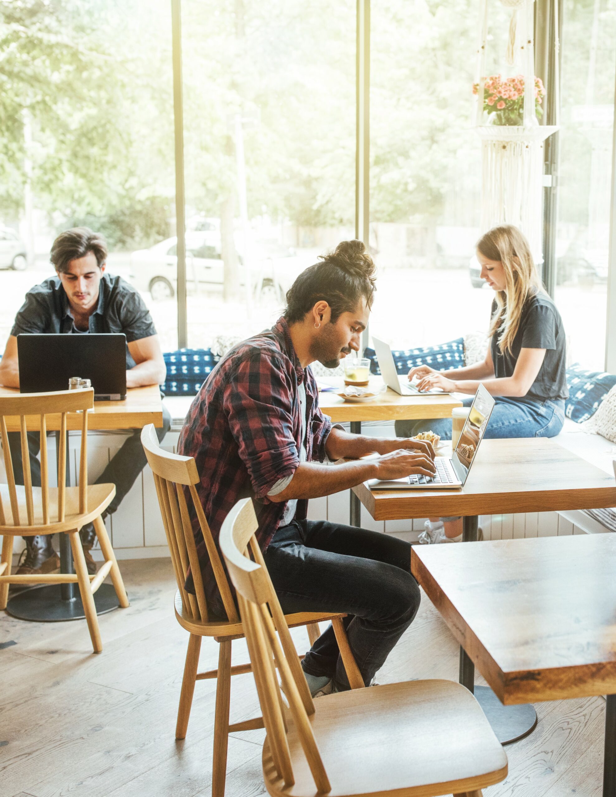 People working remotely in a café