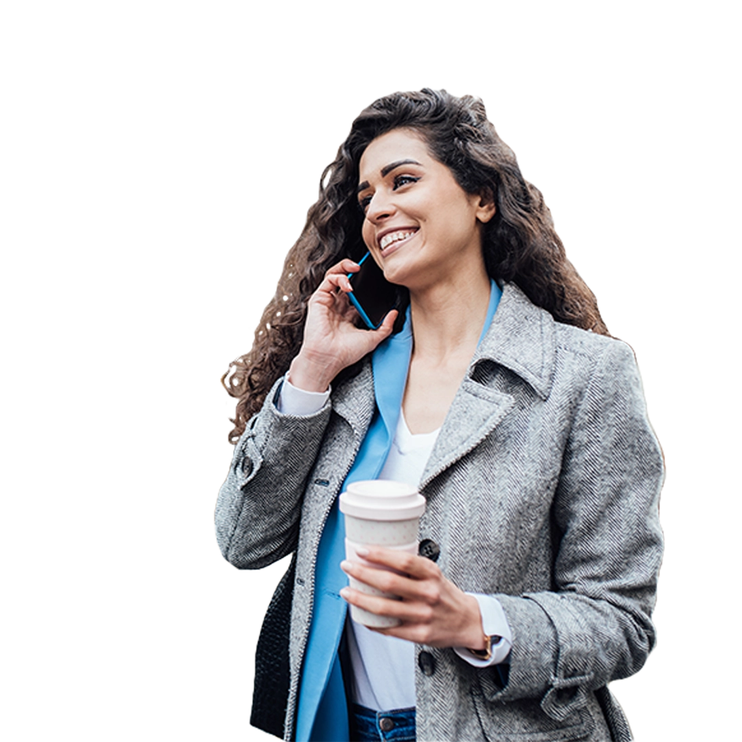 Cloud telephony enables you access to enterprise communications wherever you are Women with curly hair in gray coat smiling while talking on the phone